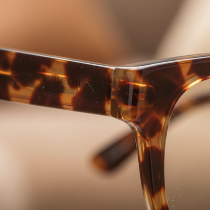 Close-up of tortoiseshell acetate frame amber swirl pattern